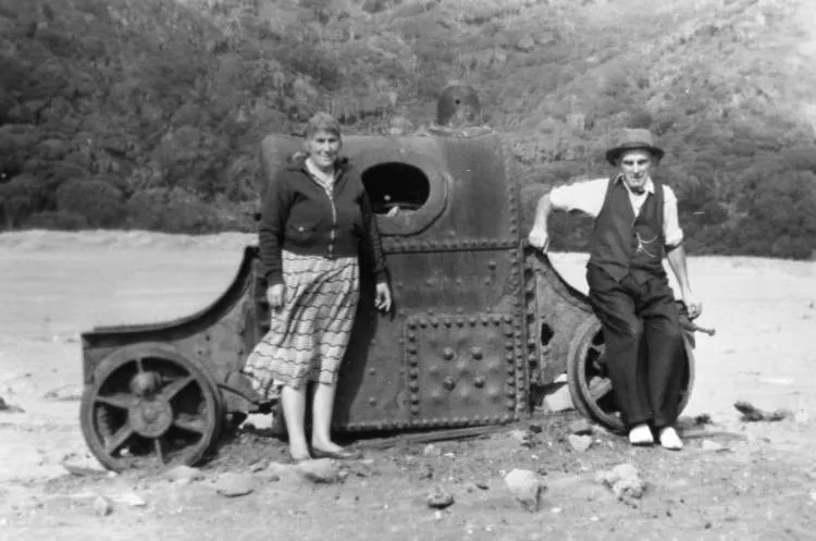 Mr. and Mrs. Murdoch by the old engine at Karekare.