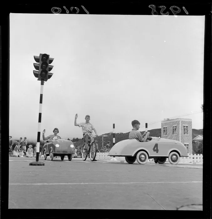 Traffic training, Karori School, Wellington, children learning to stop at traffic lights and signalling