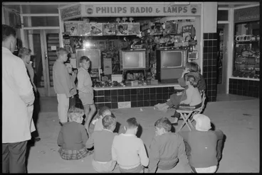 Image: Children watching television at night