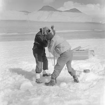 Image: A Packard and Dr R Balham cut a hole through ice