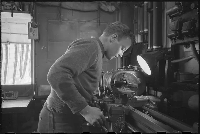 R Irving operates a lathe at NZ Divisional Field Workshops, Italian Front, World War II - Photograph taken by George Kaye