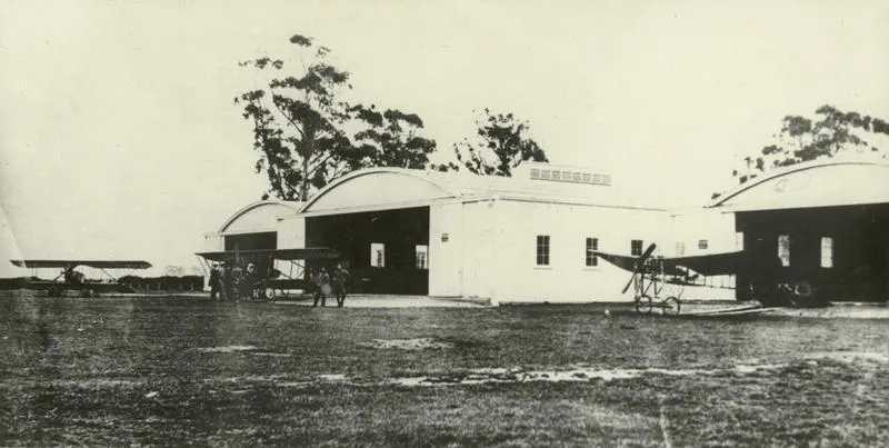 Black and white photograph of the hangars containing Caudron planes at the Canterbury Aviation Company