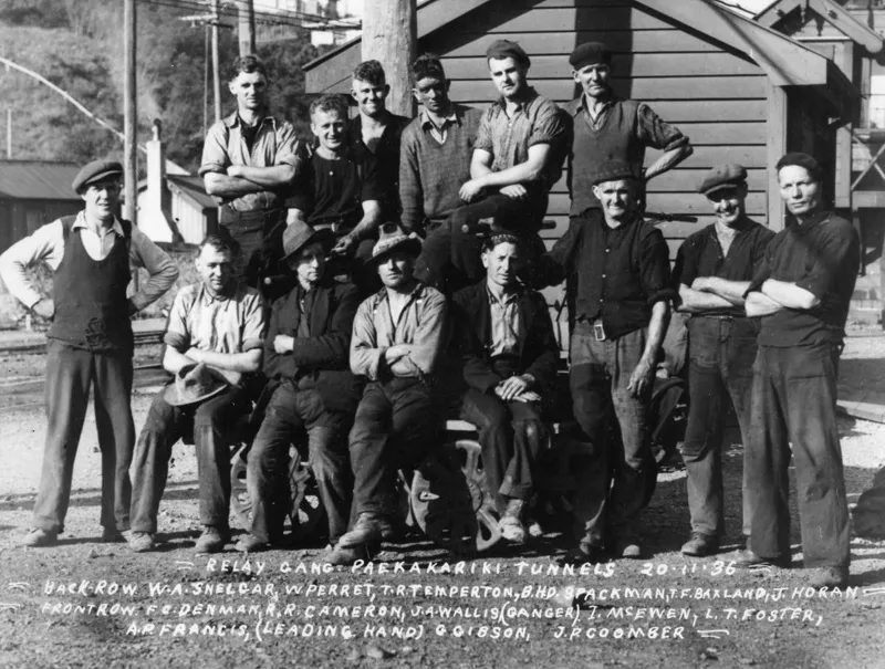 Relay gang Paekakariki Railway tunnels 20 November 1936. W A Snelcar, W Perret, T R Temperton, B H D Spackman, T F Baxland, J Horan Front row: F C Denman, R R Cameron, J A Wallis (ganger), I McEwen, L T Foster, A R Francis (leading hand), G Gibson, J P Coomber.