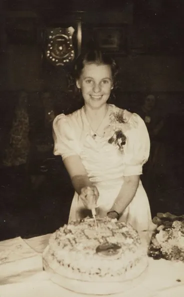 Image: Joan Larsen cuts the cake at her 21st birthday party