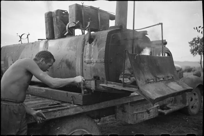 Cleaning out one of the outdoor ovens at 2 New Zealand Field Bakery in Italy, World War II - Photograph taken by George Kaye