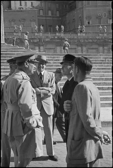 General Bernard Freyberg and others chat with Vatican official while awaiting Peter Fraser's return from his papal audience, Italy, World War II - Photograph taken by George Bull