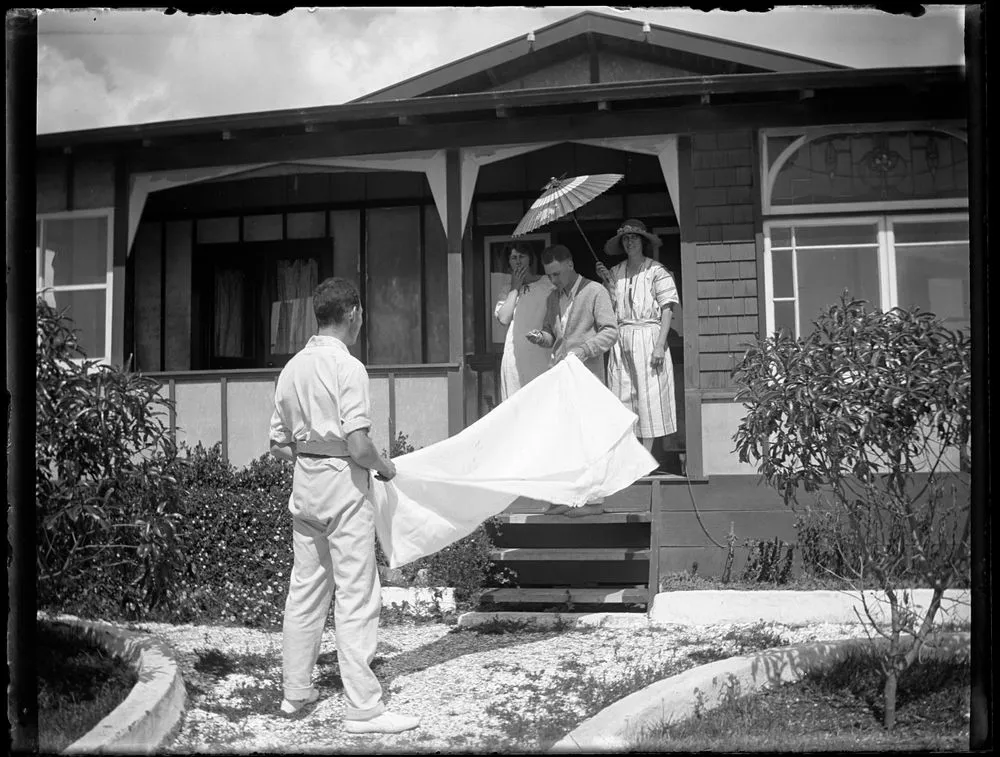 Shaking the table cloth at the Barraud's beach house, Paekākāriki