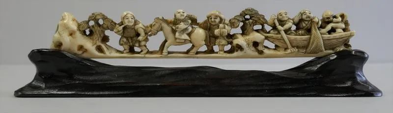 Gyosen to dochu fukei [A fishing boat and a journey, scenery]; Group with standing figures, another mounted on a horse, three more in a boat.