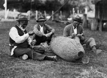 Image: Peter Buck studying Paratene Ngata making an eel basket