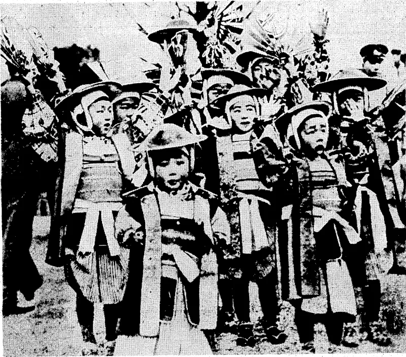 IN< THE SAMURAI MANNER— Japanese boys,: dressed:.in ancient armour, visit .the Yasukuni Shrine in Tokio on the 2996 th anniversary '■ of ; the . founding of, the Japanese Empire. ■ (Evening Post, 18 April 1936)