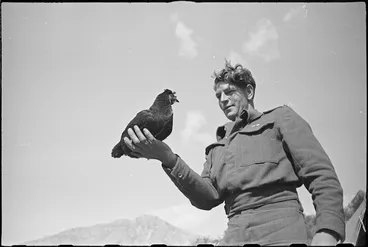 Image: M Batistich with Lulu, the hen mascot of 6 Field Main Dressing Station, Italy, World War II - Photograph taken by George Kaye