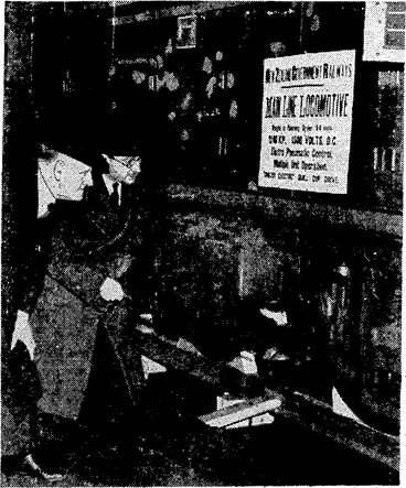 Image: The High Commissioner, Mr. W,. /.' Jordan, with "the 'assistant general manager<of the English Electric Company, inspecting the electric locomotive built for the^W'ellington-Paekakariki, section. It weighs- eighty-four .tons and'is of 1240 horse-power. The'photograph published on Tuesday was one of-the multiple-unit vehicles for the suburban service to ]ohnsonville. (Evening Post, 07 January 1938)
