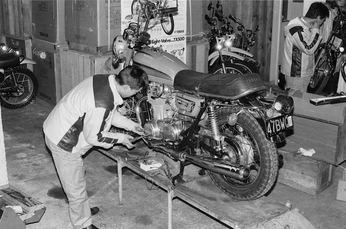 Japanese mechanic, Yoshi Ito checks his motorbike