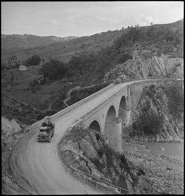 Image: Truck crossing bridge under German observation and fire in the Sangro River area, Italy - Photograph taken by George Kaye