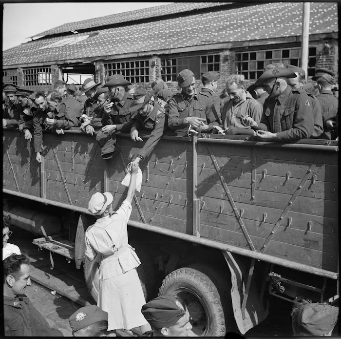 Repatriated Australian protected personnel receive Red Cross parcels as they entrain on Alexandria wharf - Photograph taken by George Robert Bull