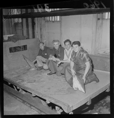 Image: Head and tail remains of a large shark on the back of a truck with four unidentified men at the Fishermans Co-Op Building, Wellington City
