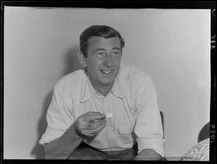 Australian actor Chips Rafferty rolling a cigarette, Wellington, New Zealand