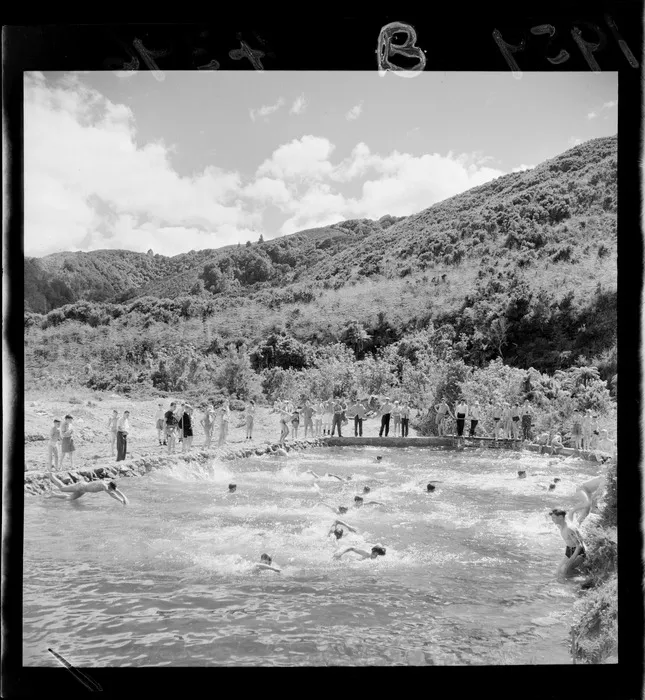 Boys swimming in dammed river, at Boys' Brigade camp, [Rimutaka Forest Park?] Wainuiomata, Lower Hutt