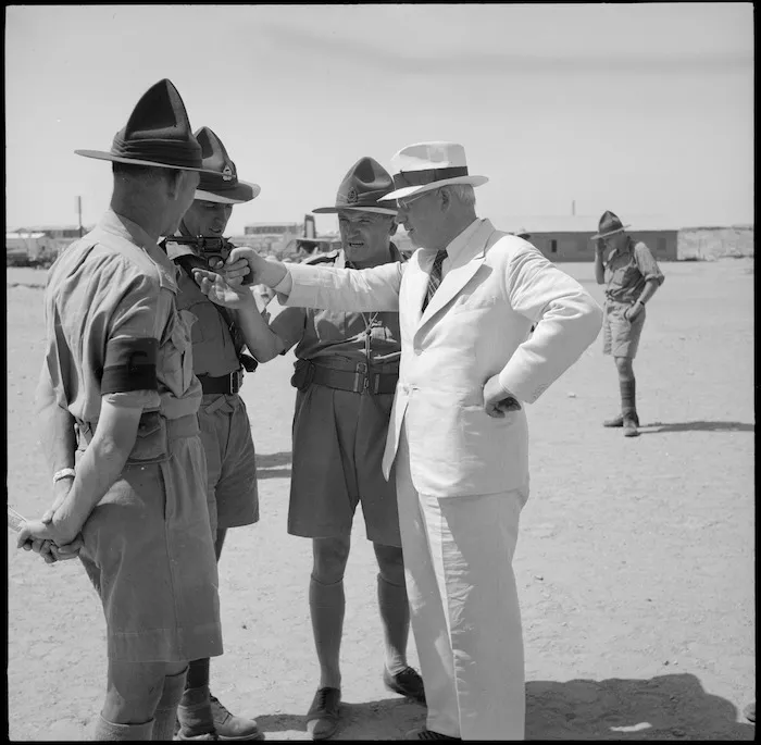 Prime Minister Peter Fraser handles a revolver at the NZ Infantry Training Depot, Maadi