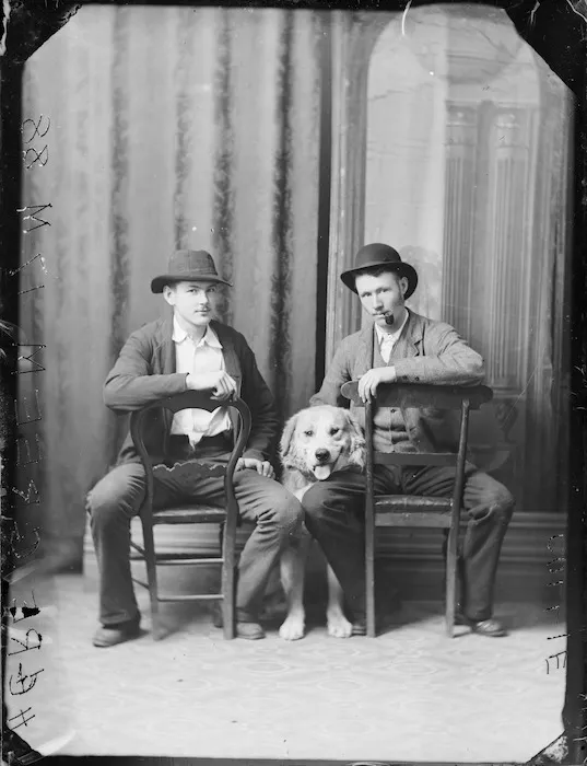Portrait of two men with a labrador dog