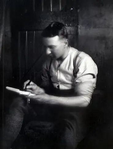 A soldier writing a letter inside : negative Image: A soldier writing a letter inside : negative