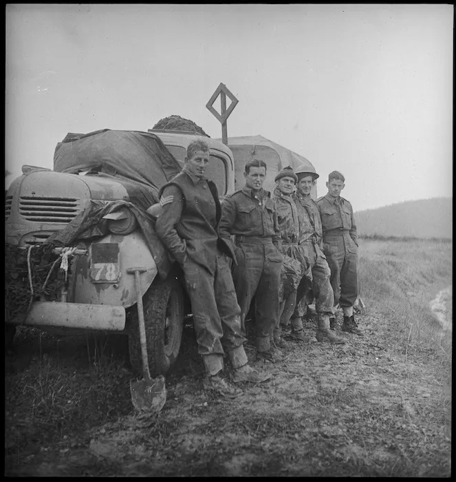 Group of New Zealanders take a break alongside truck as they move up to Italian forward areas, World War II - Photograph taken by George Kaye