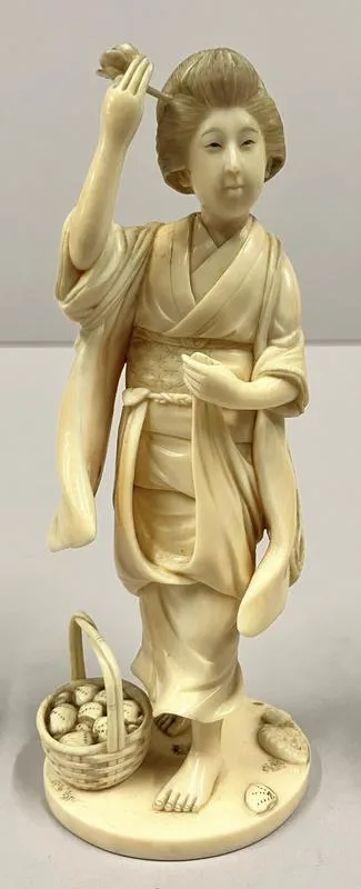 Kai o nirau musume [A Young Woman Picking Shells]; Standing figure of a woman with a basket of shellfish by her feet and shellfish on the ground