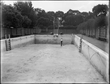 Image: Man sweeping an empty swimming pool, Christ's College, Christchurch
