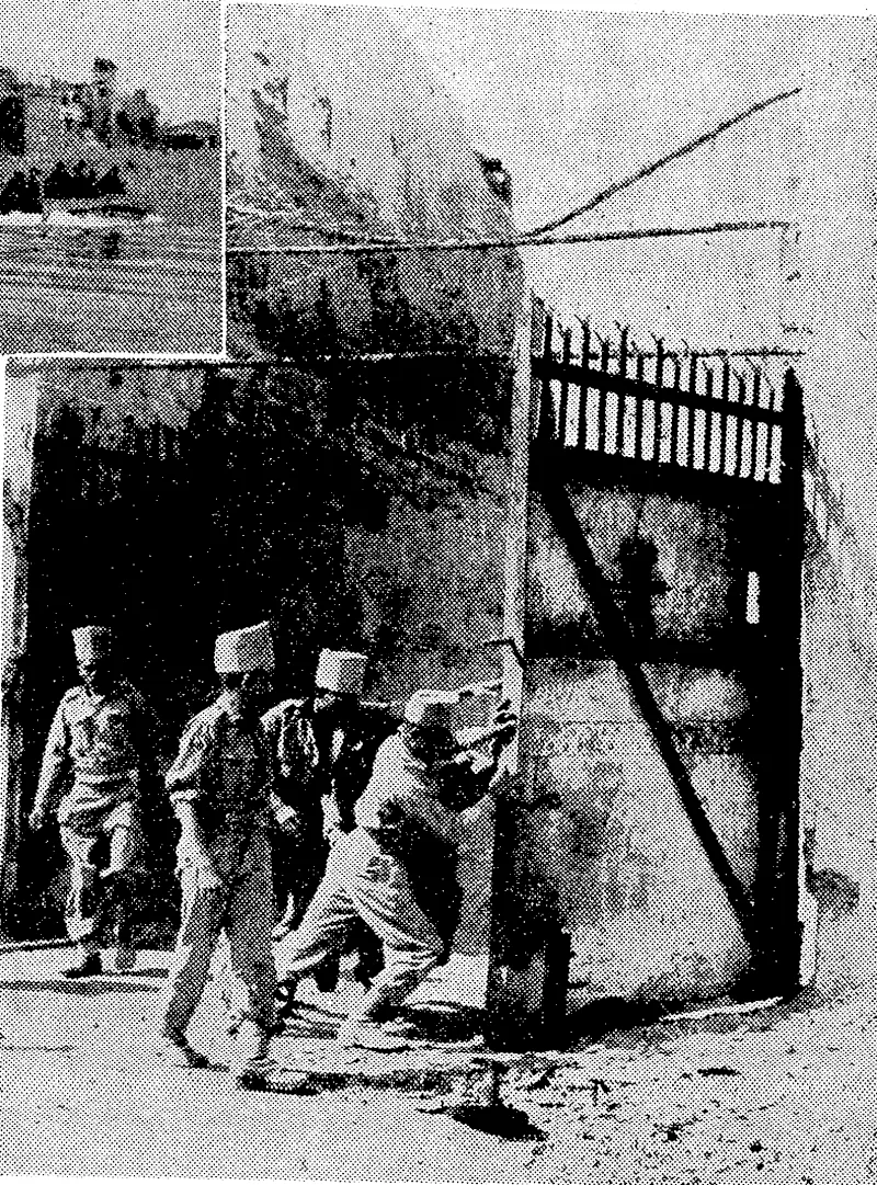 Madras sappers swing open the main gate of Fort Dufferin on March 20. The fort was the last Japanese stronghold in Mandalay, and was occupied without bloodshed, the harassed enemy having pulled out during the previous night. ~ . (Evening Post, 19 April 1945)