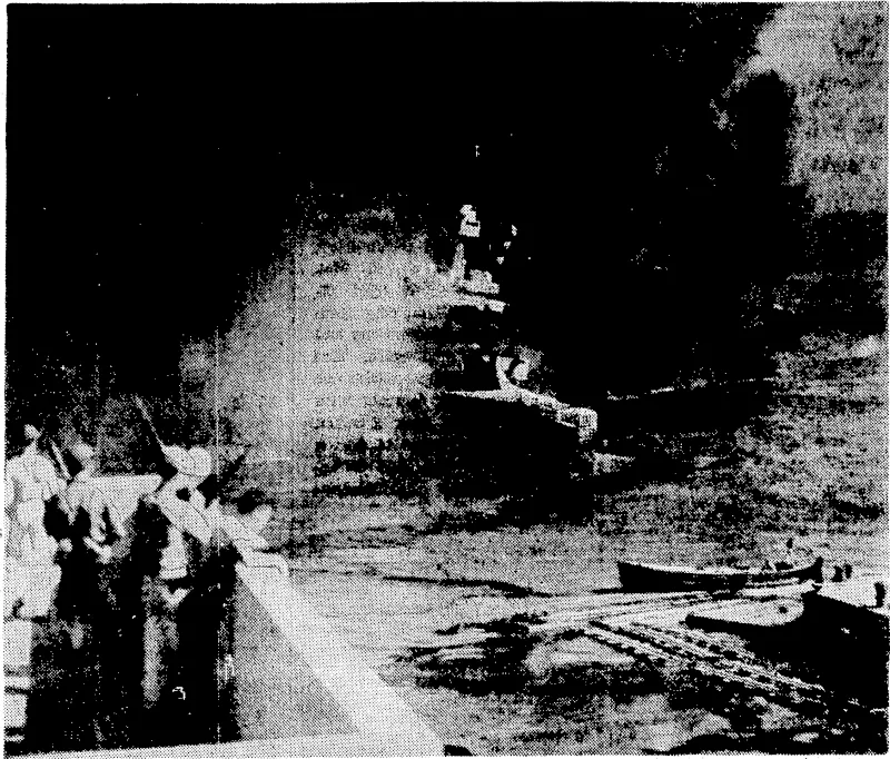 Battered by aerial bombs and torpedoes, the United States battleship California settles slowly into the mud of Pearl Harbour after the treacherous raid by Japanese aircraft. Clouds of black smoke pouring up from the California and her stricken sister-ships conceal all but a portion of the capsized battleship Oklahoma, at the extreme right. This picture was released an December 6, the anniversary of the disaster. (Evening Post, 06 January 1943)