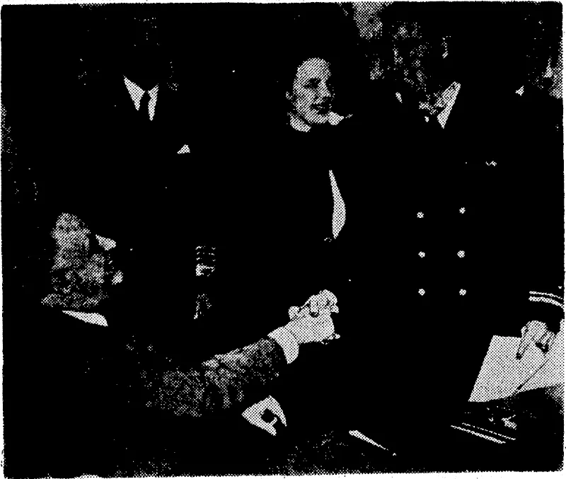 President Roosevelt shaking hands with Lieutenant Edward O'Hare, United States fighter pilot, as Mrs. O'Hare places the Congressional Medal of Honour around her husband's neck. Liejitenant O'Hare, who has now been promoted to lieutenant-commander, knocked out six planes of a Japanese bomber formation as they were attacking his aircraft-carrier. To the left, in the background, is Admiral Ernest J. King. (Evening Post, 19 June 1942)