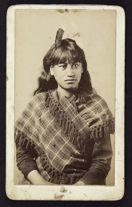 Photographer unknown: Portrait of female Māori subject wearing huia feather