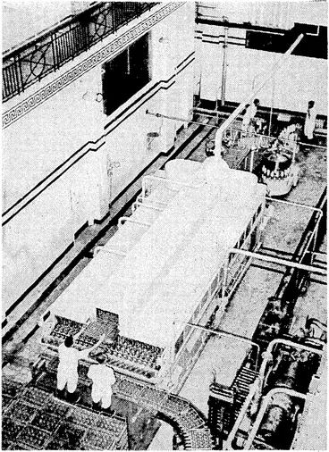Image: Evening Post" Pfcoto. This machine, recently installed at the Wellington Municipal. Milk Depot, cleans and fills the bottles in one operation. The empty, bottles enter the machine at the end nearest the camera and issue from the other end filled and topped ready for'crating and delivery. (Evening Post, 12 July 1939)