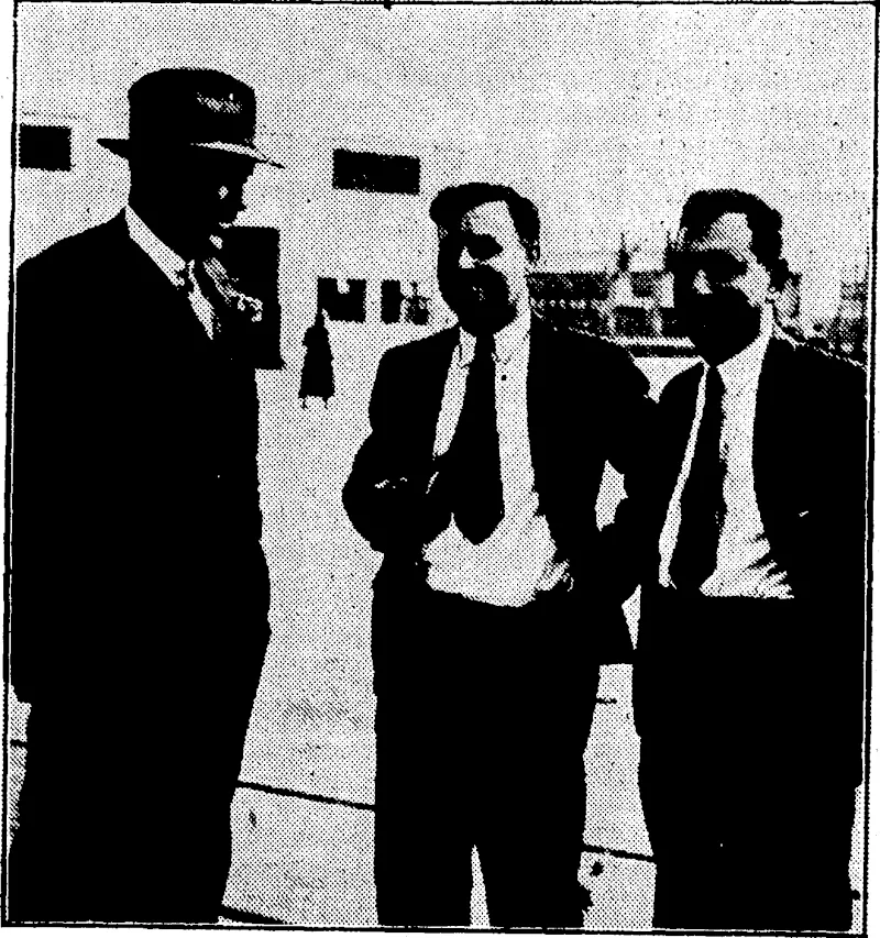 Evening Post" Photo. WHEN YOU NEED ADVICE, GO TO AN EXPERT.—Mr. Harold June (centre), Byrd's chief aviation officer, and other members of that section, has given valuable advice on flying in New Zealand. Mr. June is seen chatting with the secretary and treasurer of the Wellington Aero Club, (Evening Post, 12 December 1933)
