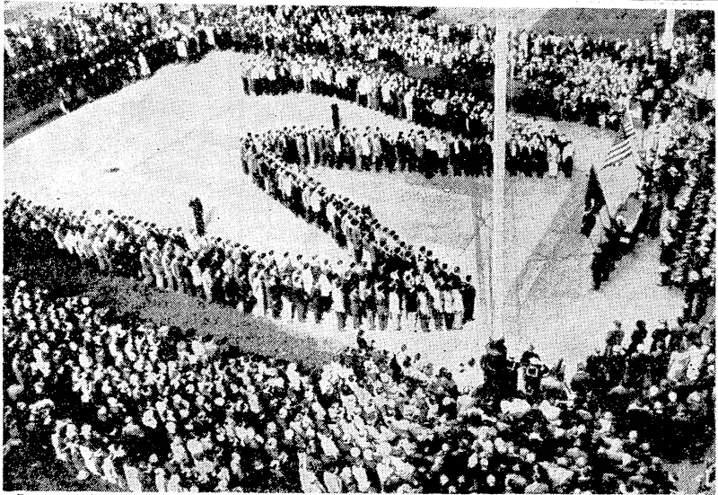 Recruits enlisting in the United Slates navy form a huge W to signify their intention to avenge the Japanese attack on Wake Island. The recruiting officer was Lieutenant-Commander J. J. Tunney, the former heavyweight boxing champion. The parade was turned into a mass ceremony dedicated to the 385 marines ivho defended Wake Island for weeks against Japanese assaults. (Evening Post, 22 April 1942)