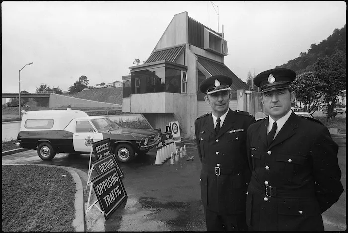 Two unidentified traffic officers near road signs to be used on the Wellington Motorway