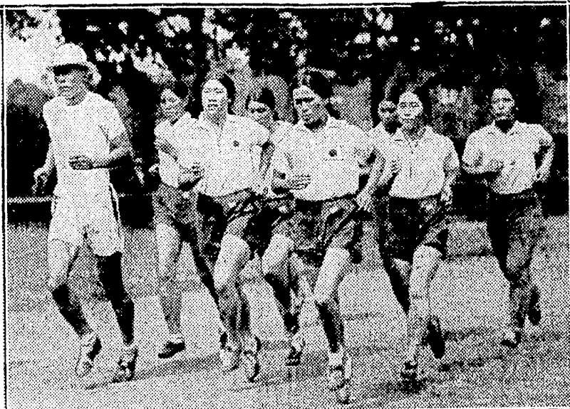Sport and General" Photo. WOMEN ATHLETES FROM JAPAN.—Within a feiv hours of their arrival in London, the Japanese girls who competed at the Women's World Olympiad at the White City Stadium, London, on August 9. were out training on the Paddington Recreation Ground. On the left is their trainer, Nakawaza. (Evening Post, 25 August 1934)