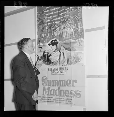 Image: Gordon Mirams looking at a poster advertising 'Summer Madness' in the Film Censor's Office
