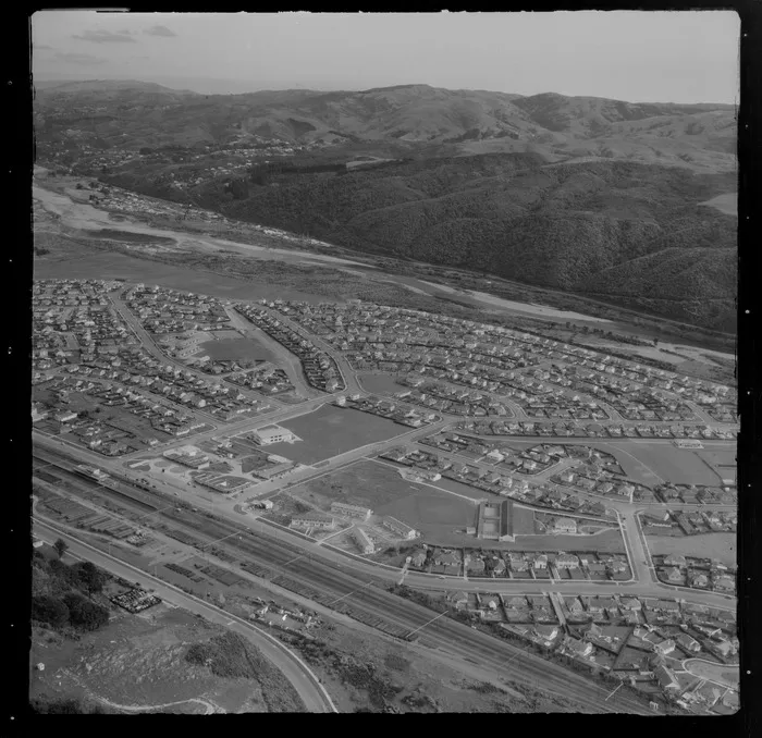 The suburb of Taita with the Eastern Hutt Road and Taita Railway Station in foreground to Taita College and the Hutt River beyond, Lower Hutt Valley, Wellington Region