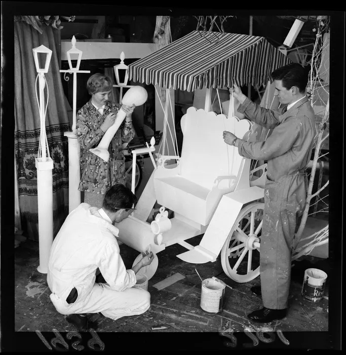 Shop verandah that has been built around a telephone pole, showing an unidentified girl leaning against pole, Wainuiomata, Lower Hutt