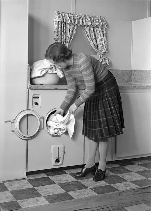 Woman using a front loading washing machine