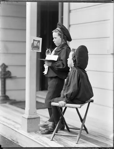 Image: Edgar and Owen, on the porch of their house; Edgar is painting a picture hanging on the pillar, Royal Terrace, Kew, Dunedin
