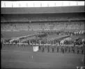 [Teams from Hong Kong, Hungary, Iceland, India, Indonesia, Iran, Ireland, Israel, Italy, Jamaica, Japan, Kenya, Liberia, Luxembourg, Malaya, Mexico, New Zealand, Nigeria, North Borneo, Norway, Pakistan and Peru assembled at the opening ceremony, Olympic Games, Melbourne, 22 November 1956] [picture].