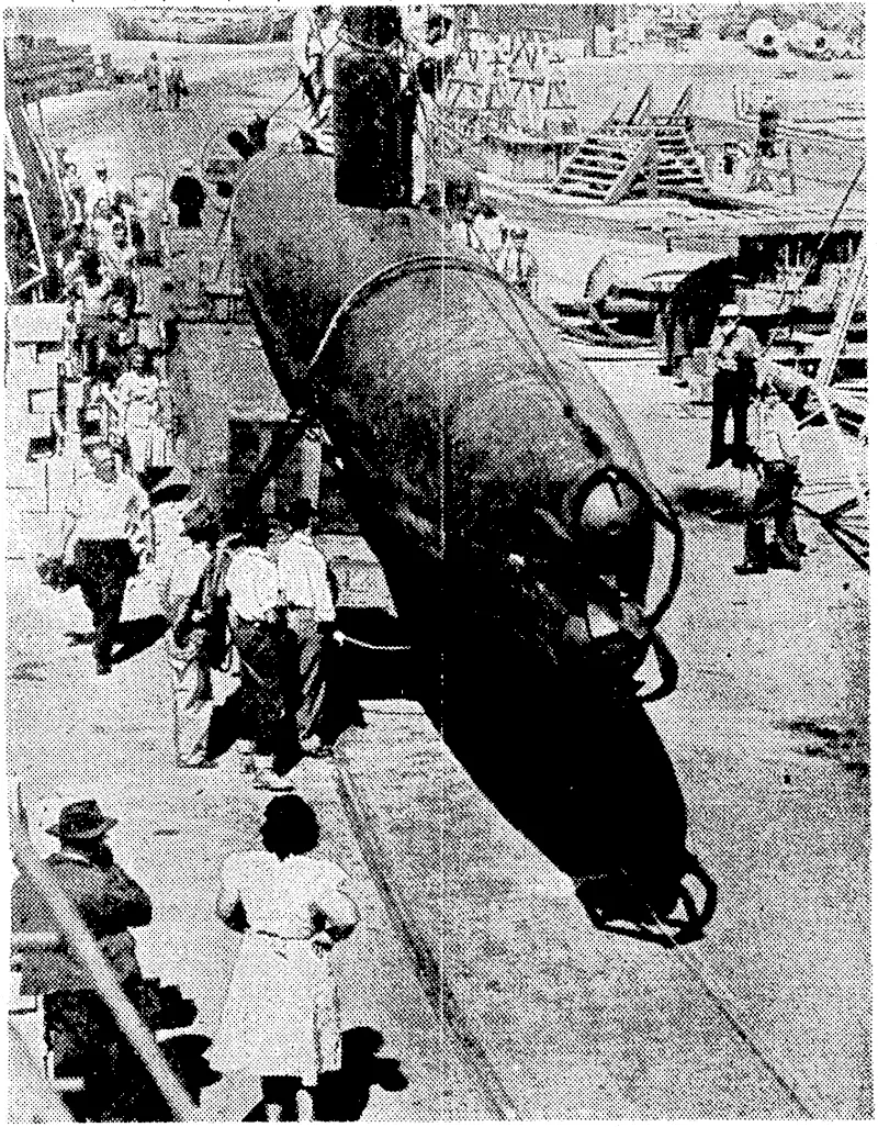 Japanese two-man submarine, captured by American forces in the Pacific, landed at a West Coast naval yard, where s United States engineers examined its construction. The bow of the craft is pointing towards the camera, and ih<: capped tubes cover two torpedoes, which are the main armament of these submarines. (Evening Post, 20 November 1942)