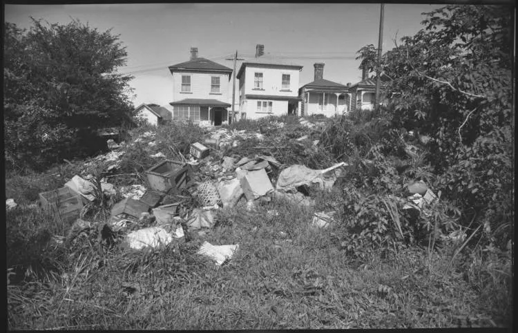 Rubbish dumped behind houses, Freemans Bay, 1962
