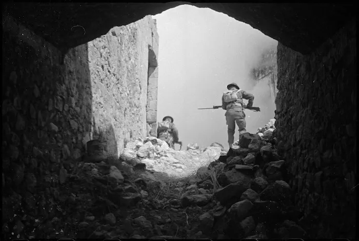 Soldiers moving through ruins on the Cassino battlefront, Italy - Photograph taken by George Kaye