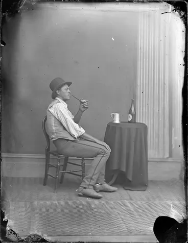 Image: Unidentified Maori man with a pipe, tankard and bottle of beer